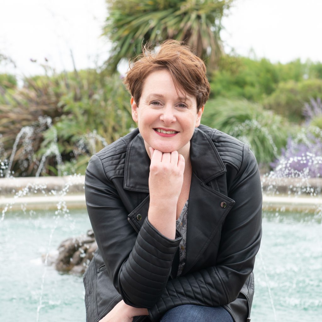 Catherine Jones Copywriter sits in front of a fountain in Bognor Regis